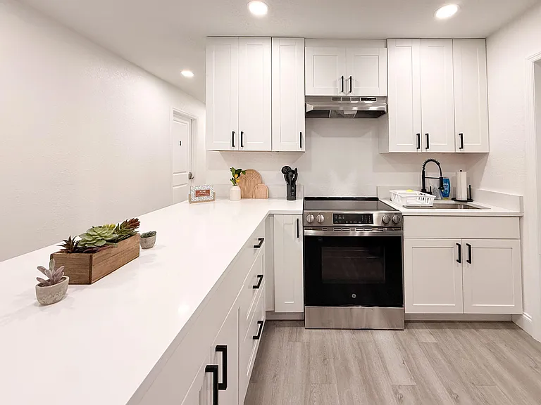 Updated kitchen with shaker cabinetry, ample counter space, and stainless range plus a deep sink for easy meal prep.