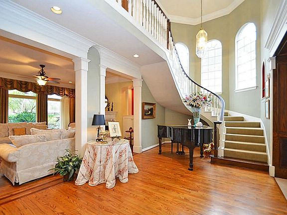 THE ELEGANT FOYER  FEATURES RICH HARDWOOD FLOORS AND A SWEEPING STAIRWAY!