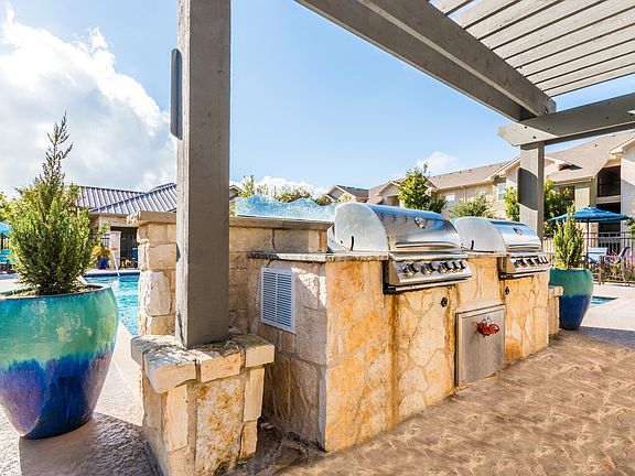 Entertain poolside with an outdoor grilling area and dine al fresco