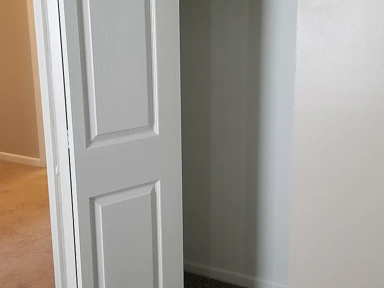 Closets feature bifold doors, shelf, and hanging rod.