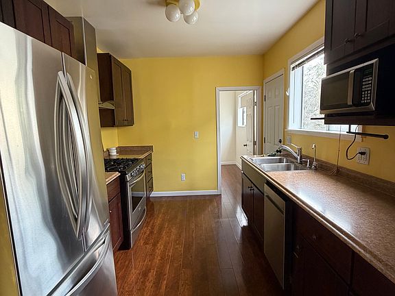 Kitchen with fridge, dishwasher, microwave, gas stove