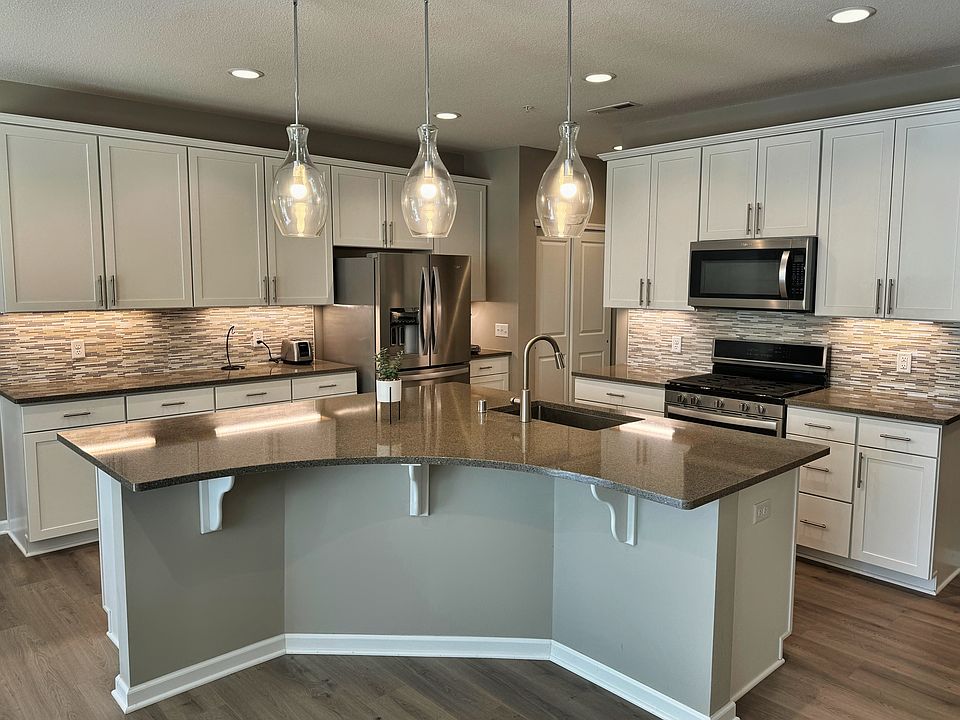 Quartz countertops, stainless appliances, and large center island