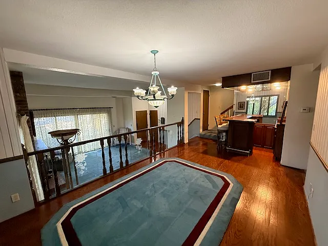 Dining room with a view of the living room and wet bar.