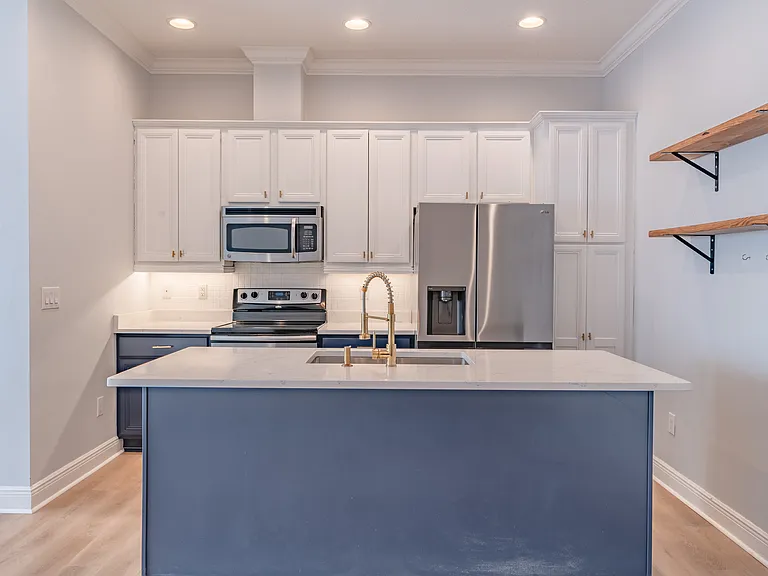 The island easily accommodates 3 bar stools and plenty of cabinet and pantry space!