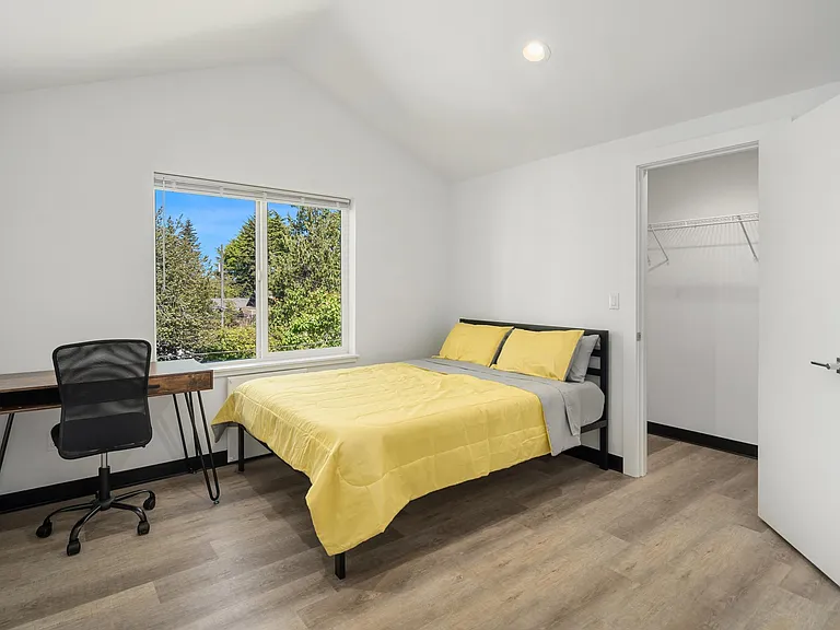 Furnished bedroom with vaulted ceilings