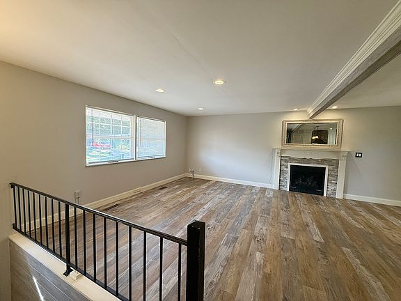LIVING ROOM AT TOP OF LANDING REFLECTING THE GAS FIREPLACE.