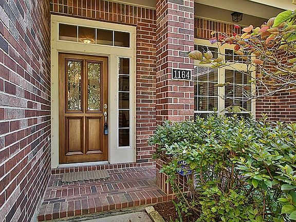 Entrance With Lead Glass Front Door & Brick Flooring On The Porch.