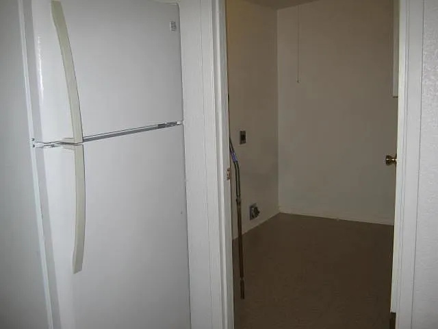 View into laundry room. There is a door to close off the entrance into the laundry room