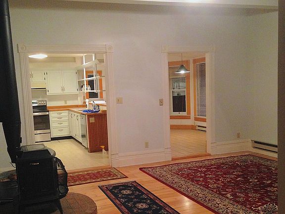 Living room looking into kitchen and dining area.