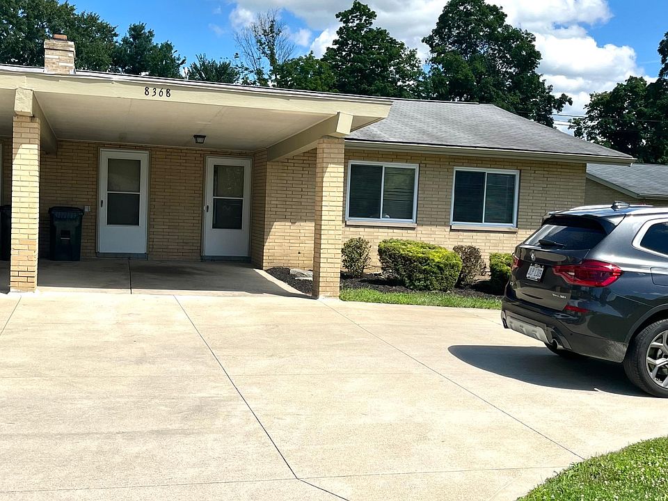 Duplex front view with carport and 2 additional parking spots