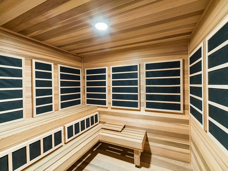 An infrared sauna with warm wood finishes and quiet seating, offering a restorative setting to unwind and reset at your own pace.