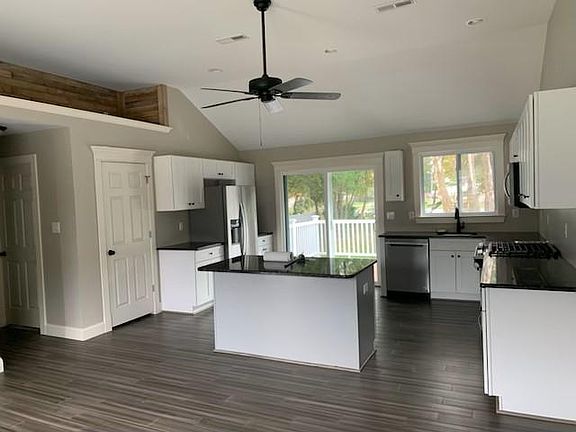 New kitchen, with stainless steel appliances and granite countertops.
