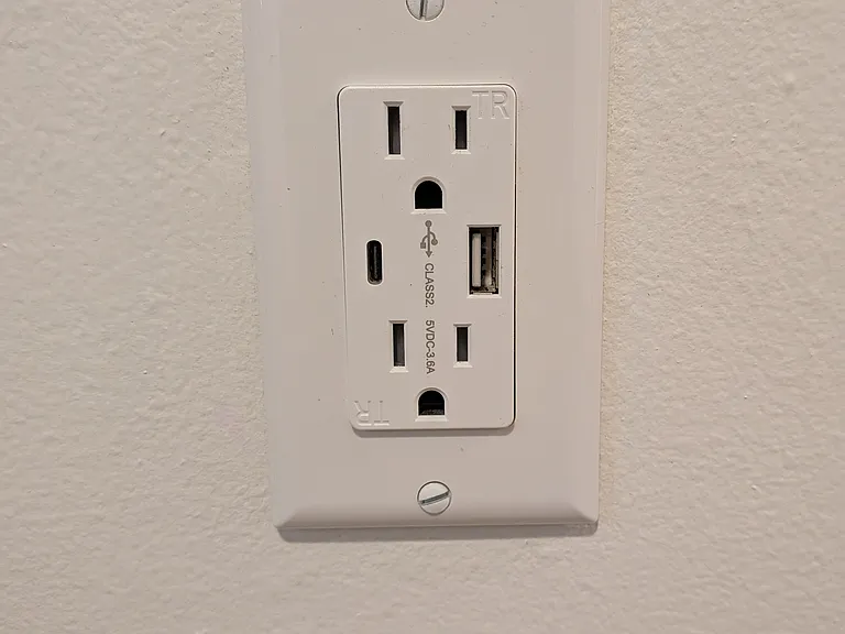 Living room and bedrooms outfitted with USB and USB-C outlets.
