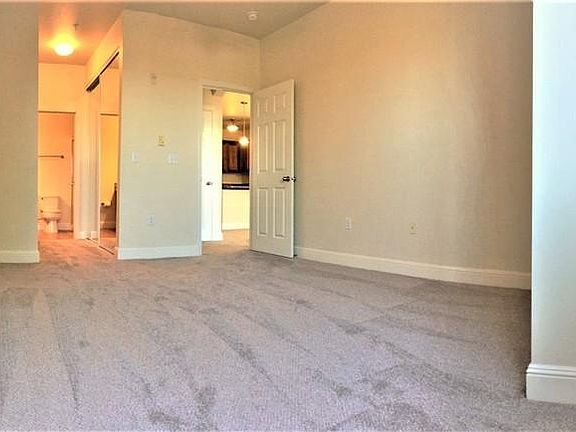 Large master bedroom with private bathroom and two large closets, windows look out on private, fenced yard