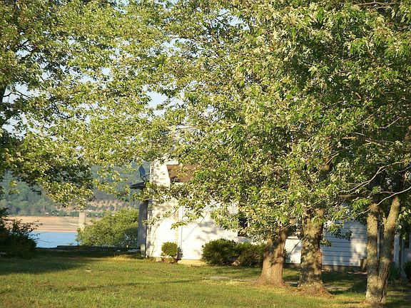Showing house with lake in background.