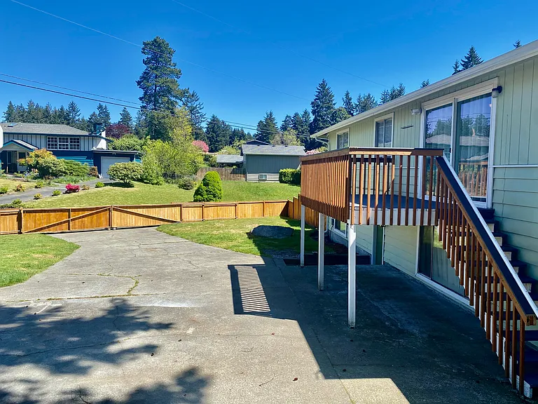 Large backyard with gated fenced area.