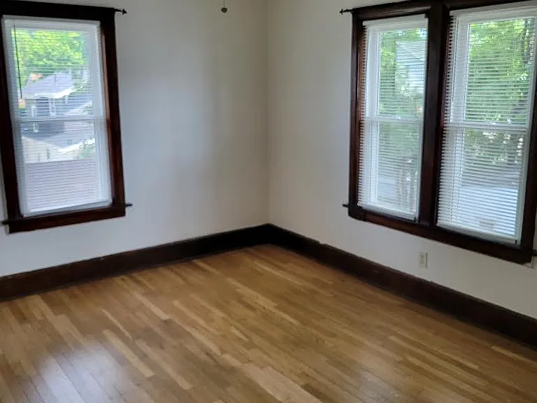 Rear master bedroom with ceiling fan and new windows.