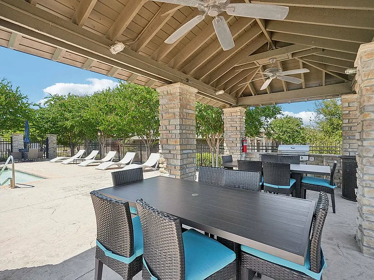Relax and enjoy a barbecue by the pool at Arroyo Seco Villas in San Antonio, TX.