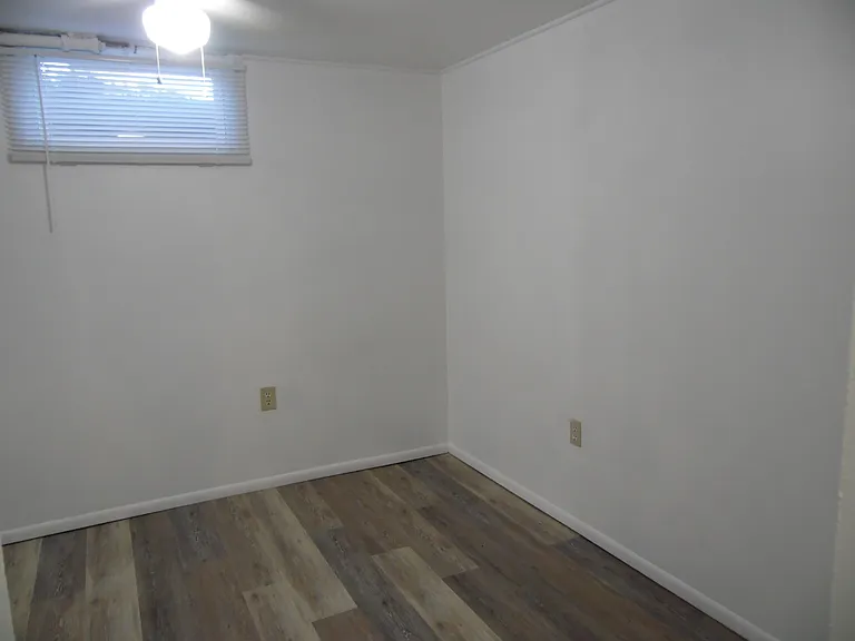 The bedroom can easily fit a full size bed with room for a dresser. The blinds allow you to control the natural light in the room.