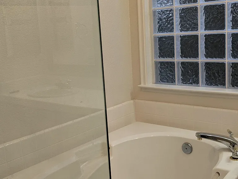master bath glass shower and separate jacuzzi tub