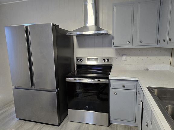 Kitchen with new fridge, range and hood