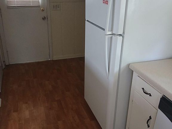fridge is by the back door, which leads to garage.