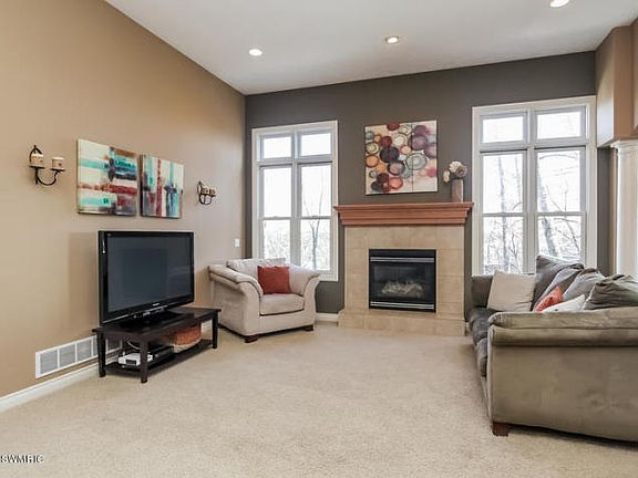 THE VERSATILE GREAT ROOM IS THE PERFECT PLACE TO RELAX OR ENTERTAIN, WITH BRIGHT NATURAL LIGHT AND COZY GAS FIREPLACE!
