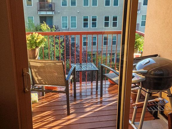 Private balcony overlooking green space.