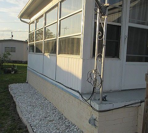 Left side, enclosed porch