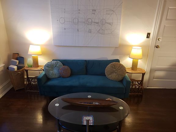 Living room includes yoga mats, yoga blocks, and other yoga equipment
