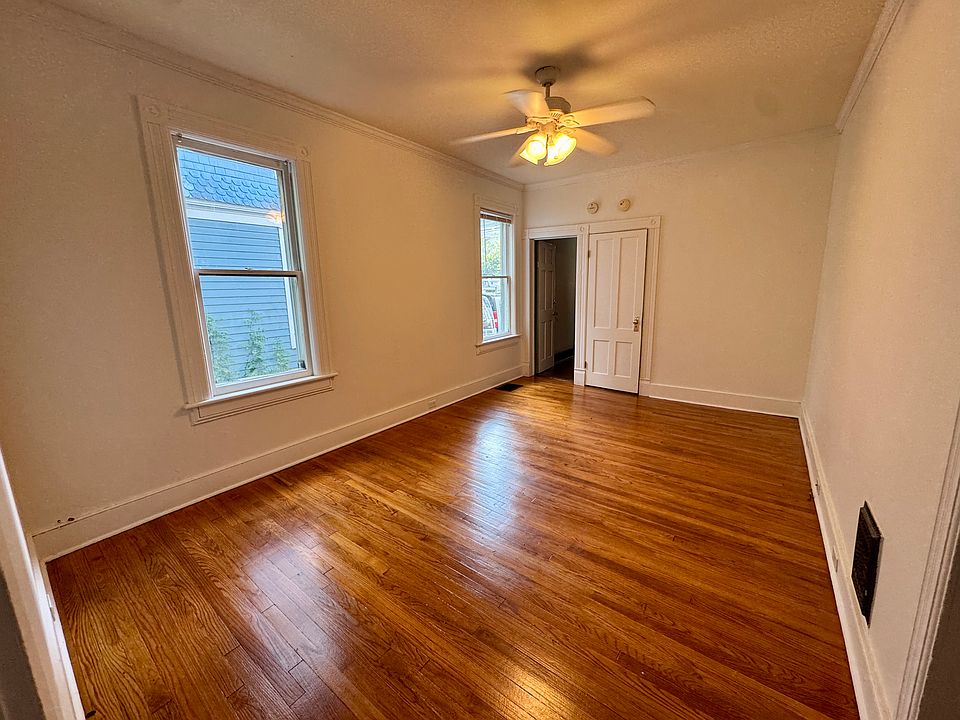 Living room, refinished hardwood floors and tons of light.