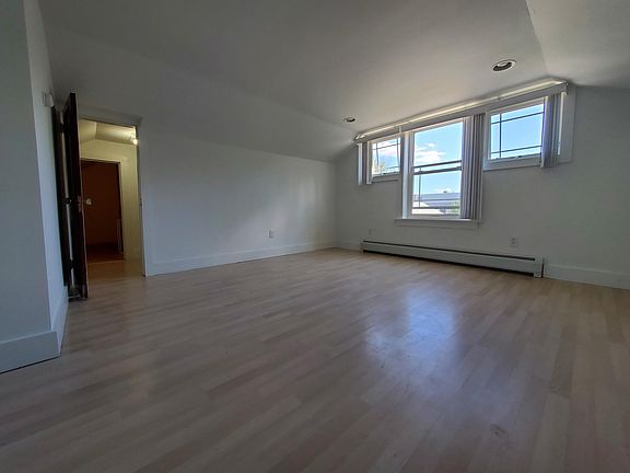 Upstairs master bedroom. View into walk-in closet and door to storage under eaves
