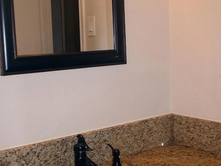 Master bedroom sink, granite counter top, copper sink, and bronze fixture