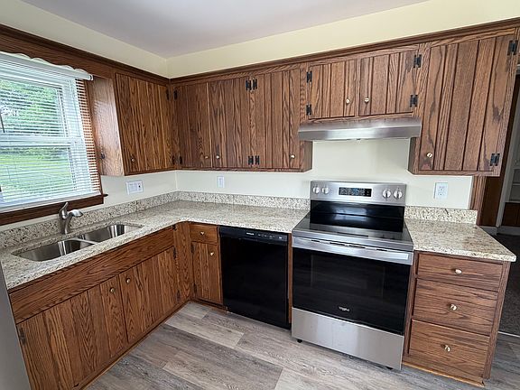 New custom cabinets above stove and on right lower side. Beautiful new granite countertops, kitchen sink and faucet! New stove/oven, oven hood, and dishwasher! New refrigerator too!