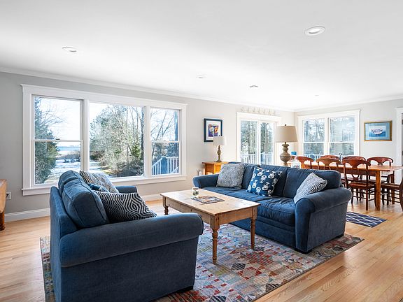 Open floor plan: living room with gas fireplace, dining room, and kitchen. All with views of the ocean.