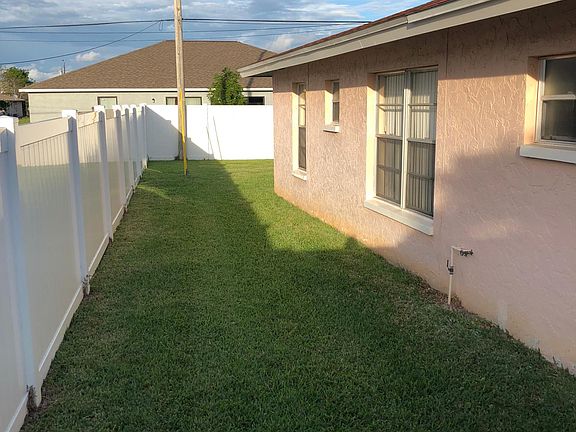 Entrance from fence gate to backyard.