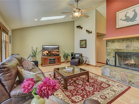 From the foyer, the living room awaits you with a warm fireplace. 
