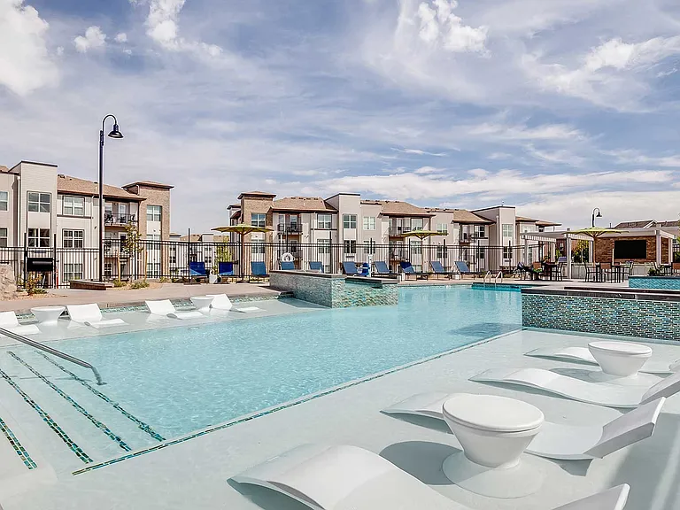 The Wright's expansive pool deck features in-water loungers, outdoor gathering spaces, and modern amenities designed for relaxation and connection.