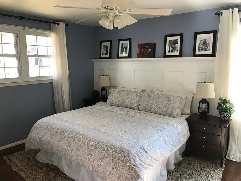 Master bedroom with board & batten wall, shown here with King bed