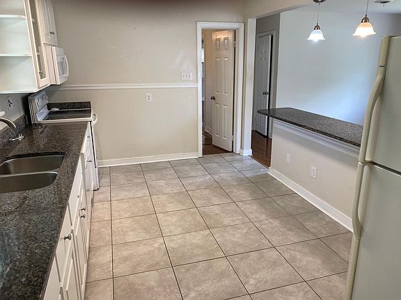 Kitchen with granite counter tops & easy clean floor tile