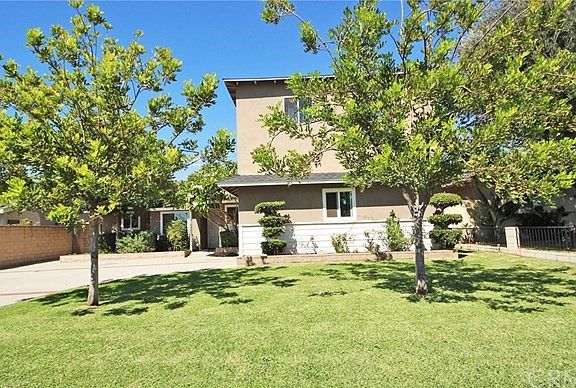 Front yard with healthy lawn and shade trees