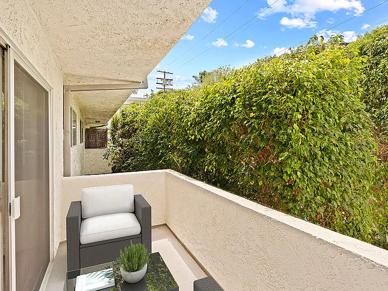 Private balcony with seating area and lots of light.