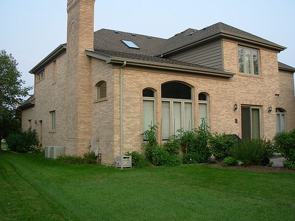 Rear of house, note two air conditioners, and paver patio.