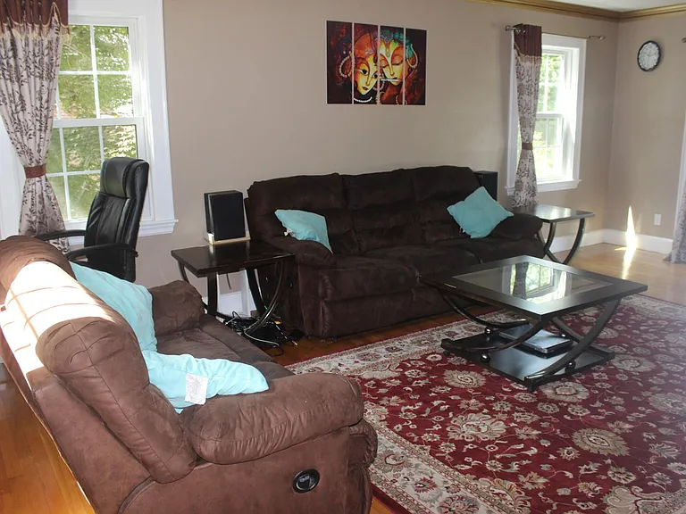 Living room with 3 windows and 1 French door opening to Sun room enables plenty of natural light