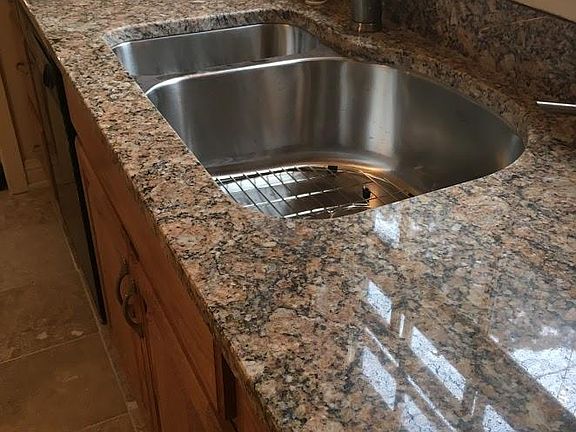 Remodeled kitchen with granite countertops and stainless steel sink