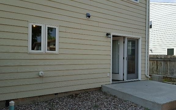 Privacy fenced backyard with patio and alley access.