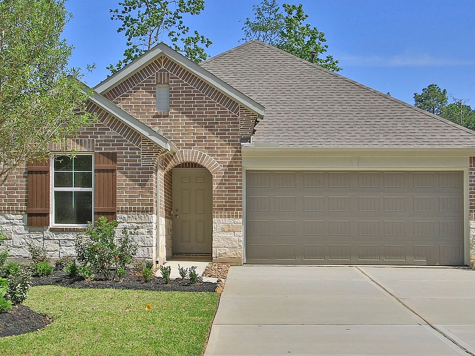 Experience elegance with a brick facade, stone accents, and gable roof. Nestled in The Woodlands Hil