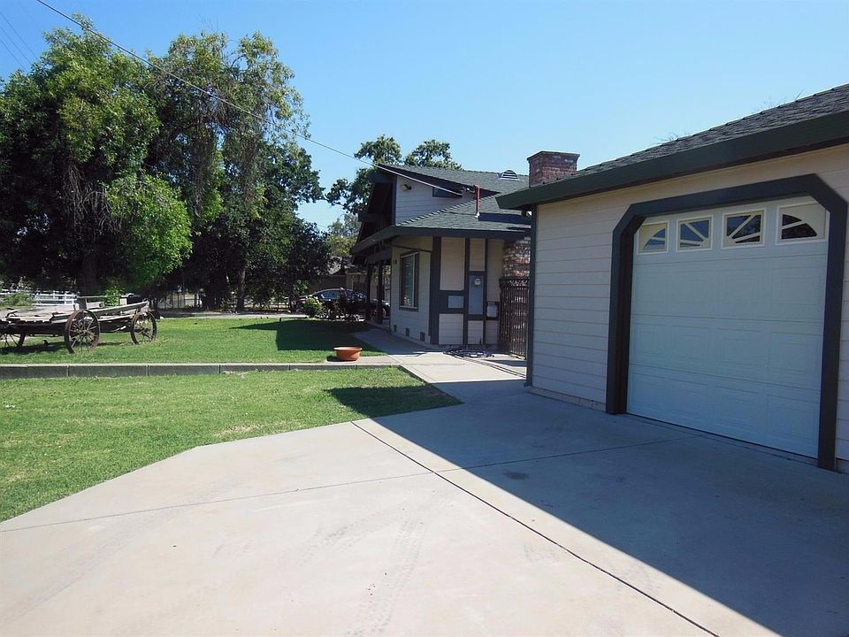 Front view of home with garage area showing. Note, 2nd driveway for added parking on other side of t