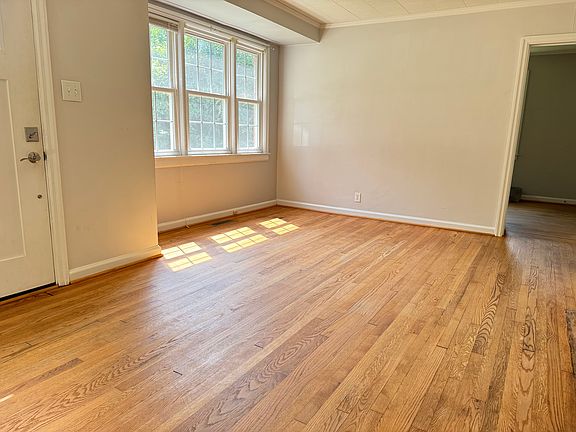 Living Room w/ natural, Scandinavian finish on original hardwood floors.