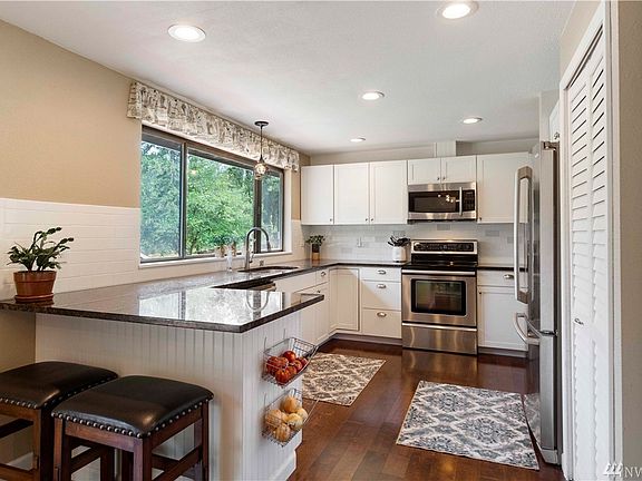 The kitchen is light and bright and all appliances stay with the home. 